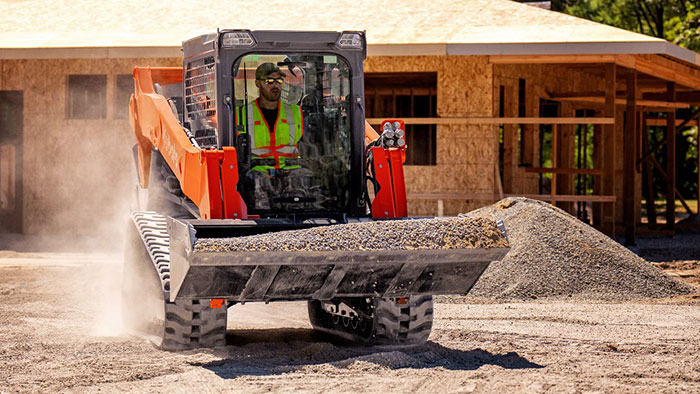 Kubota track loader moving rocks